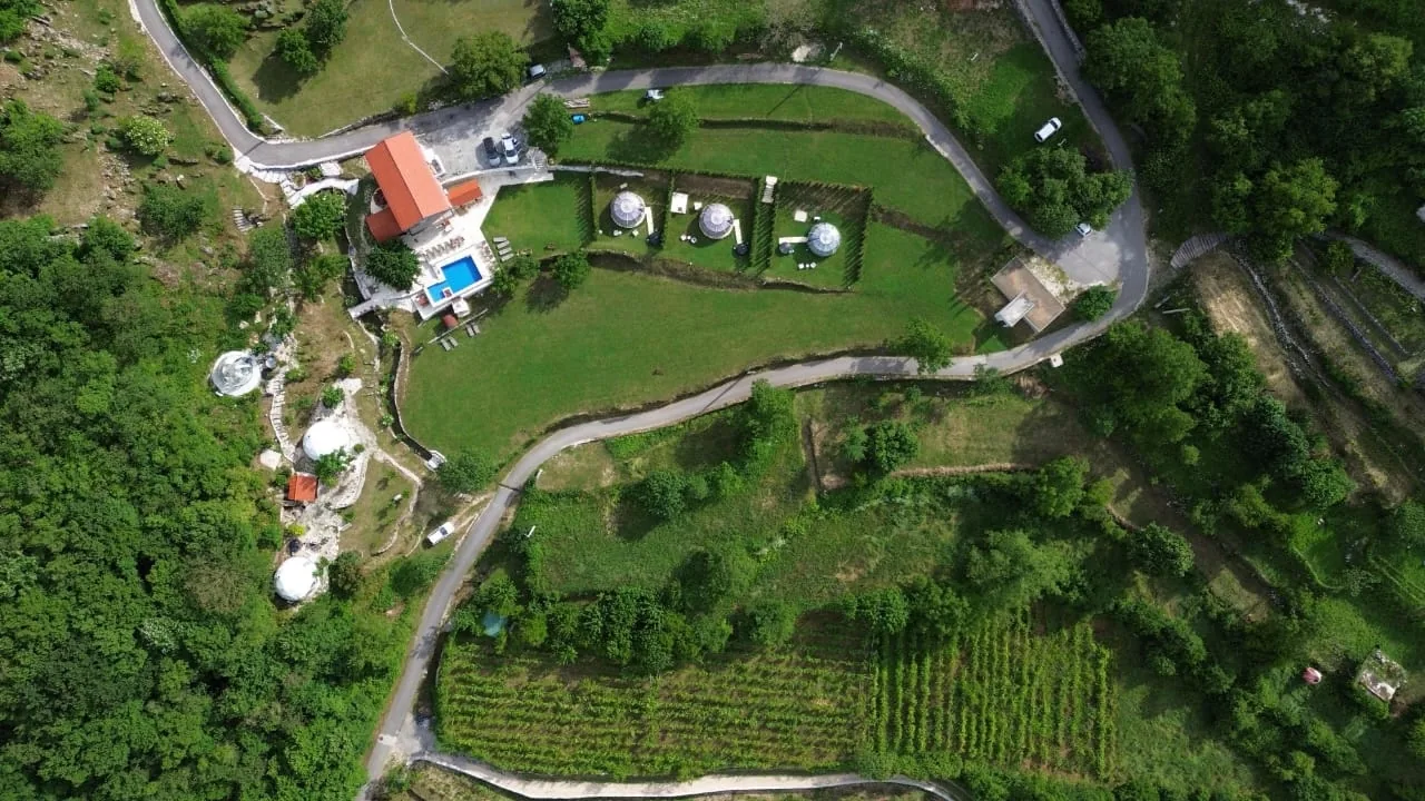 Aerial drone view of the Zen Relaxing Village domes, pool and vineyard in the mountains of Gornji Ceklin