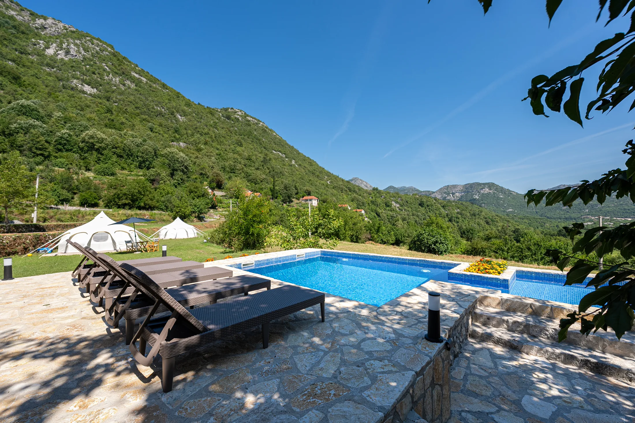 Swimming pool and sun loungers overlooking the mountains at Zen Relaxing Village, Montenegro